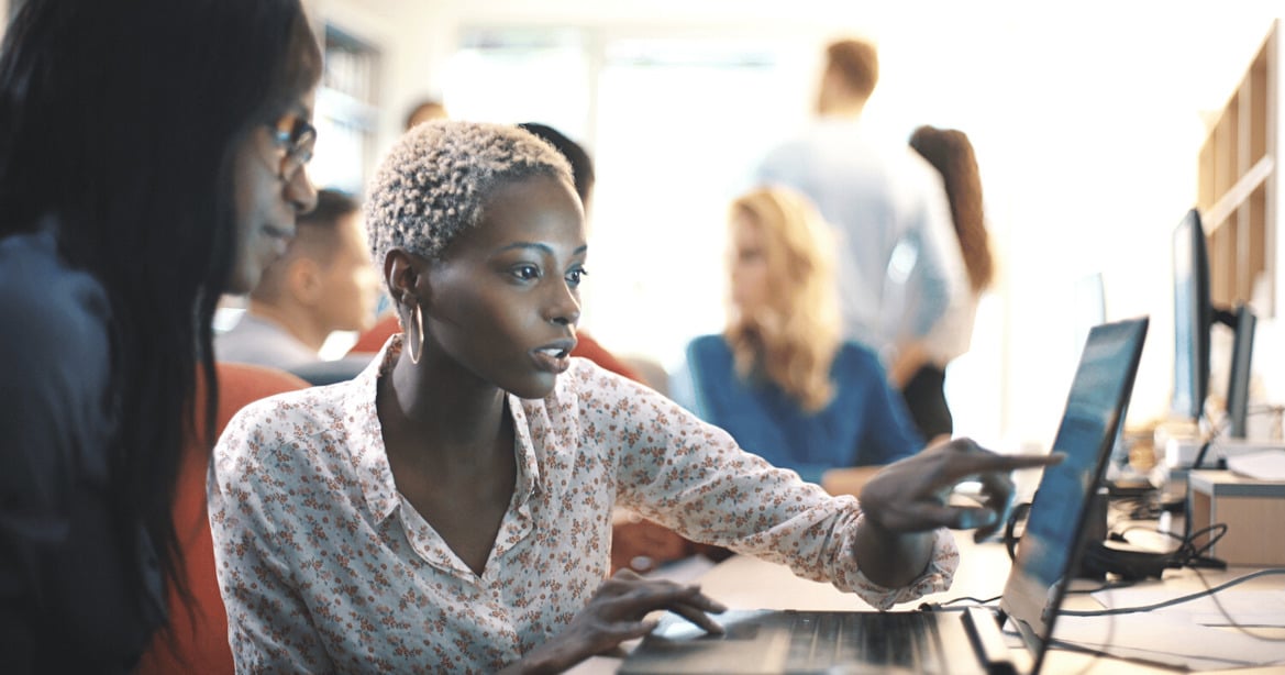 IT team reviewing email security using laptop at office desk