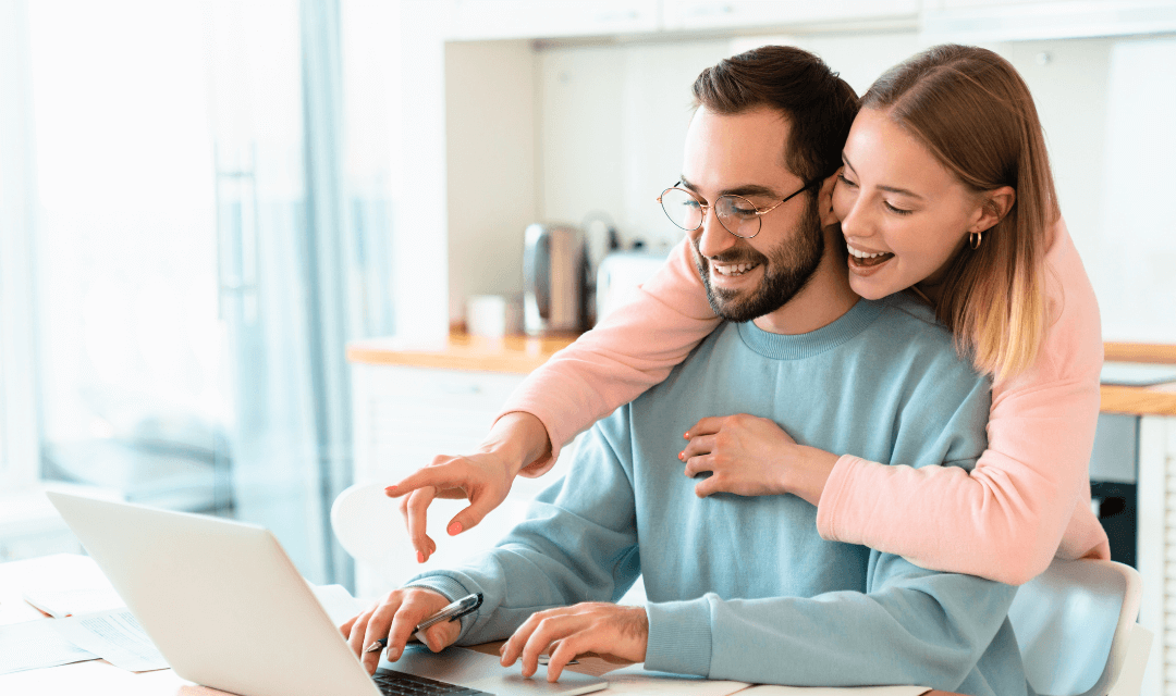 Couple looking at financial information on their laptop-1