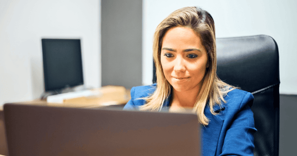 Financial services professional emailing on her laptop