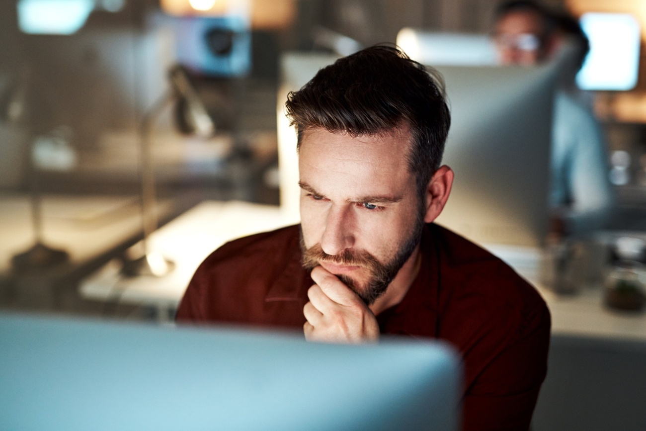 IT team member looking at computer with email encryption-1-1