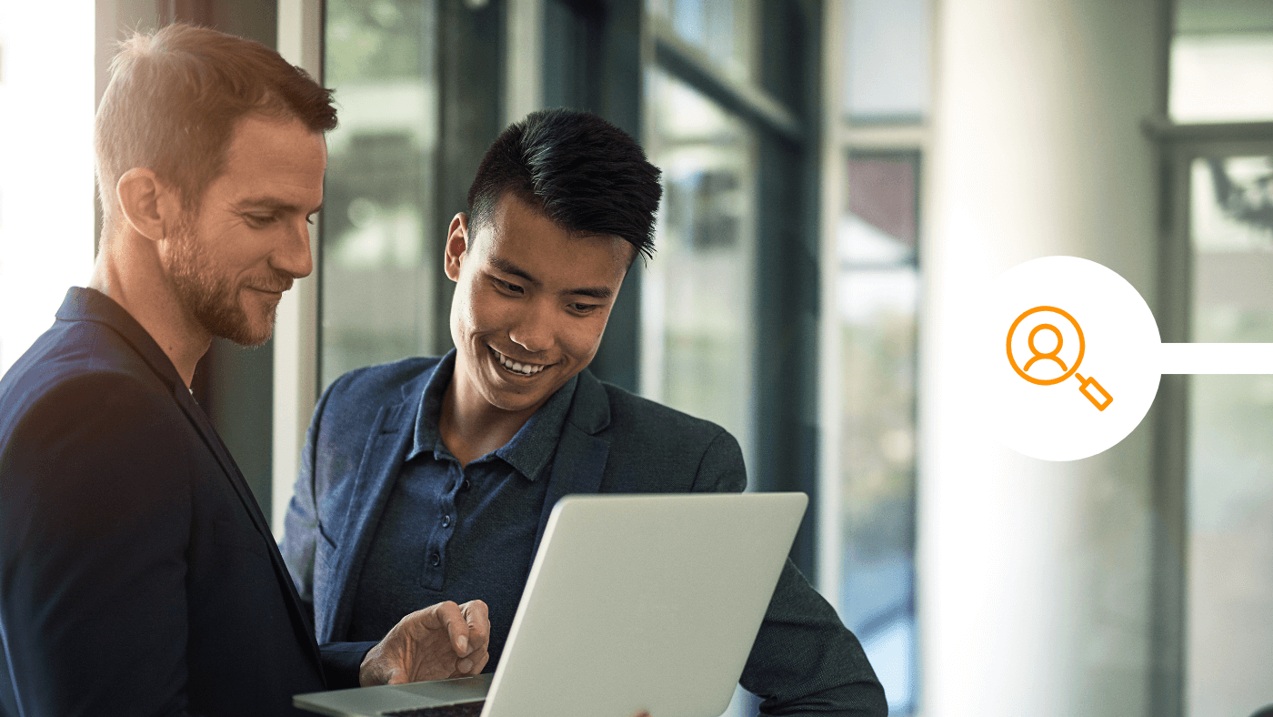 Male business people looking at digital identity tech together in office