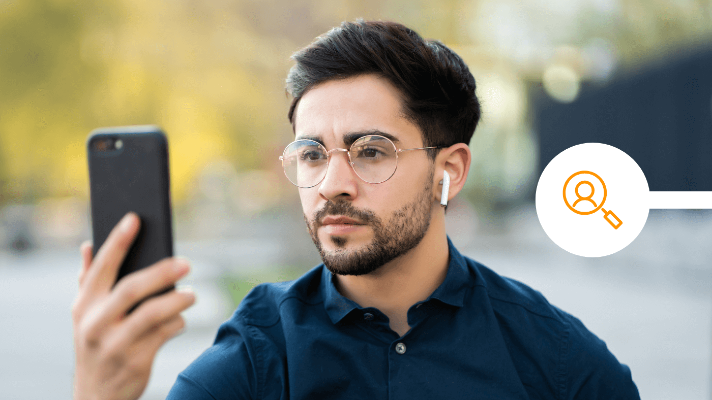 Man with glasses using smartphone to verify digital ID