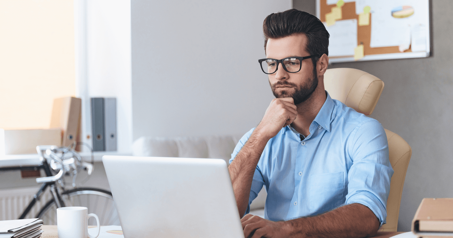 Professional man using laptop to send secure emails in office