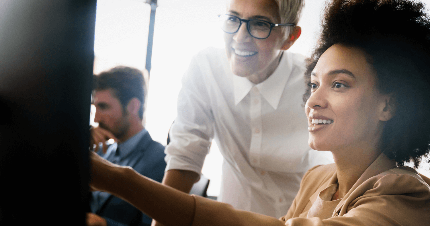 Professional team looking at computer together in office