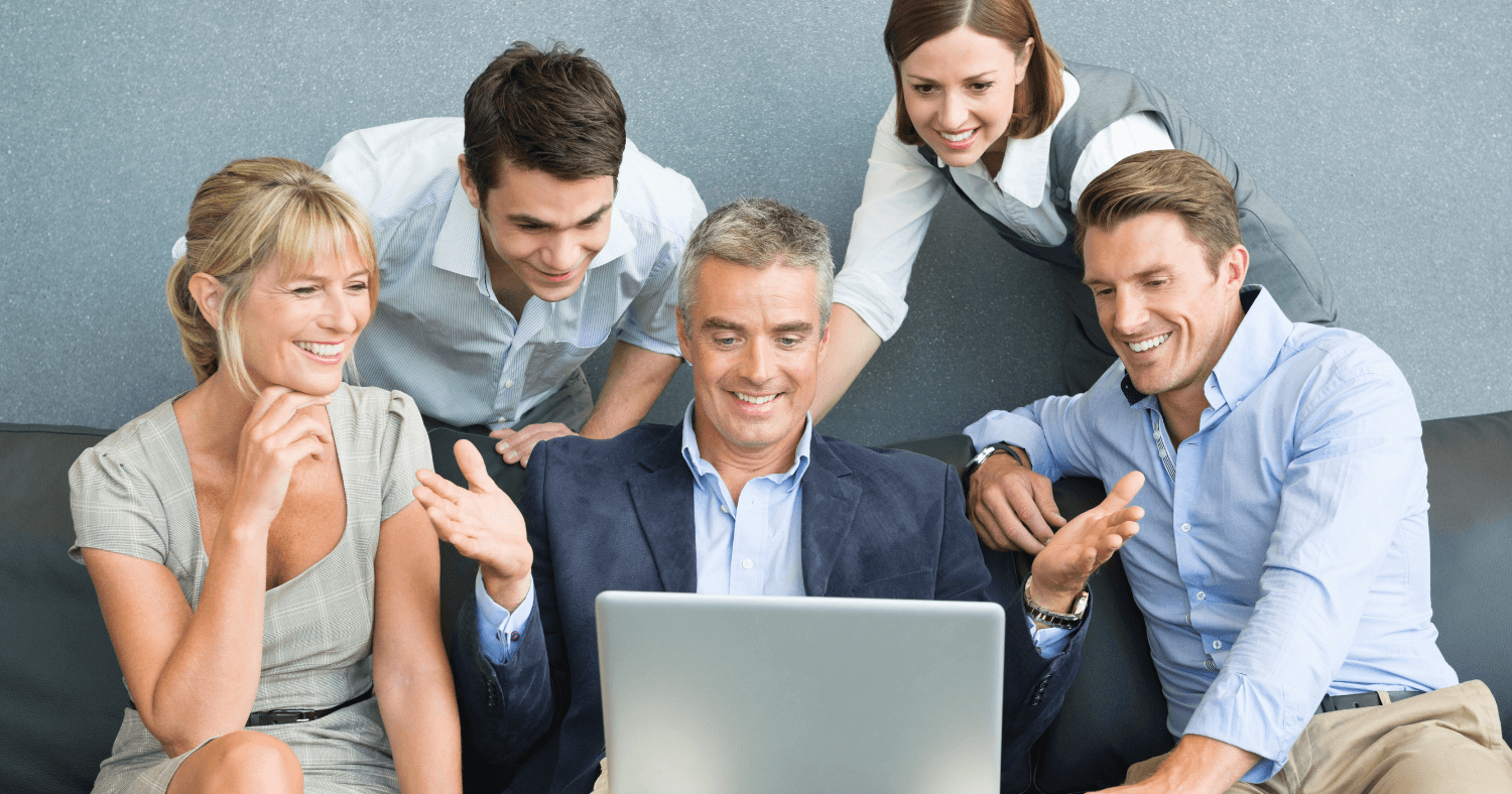 Professional team looking at laptop in office