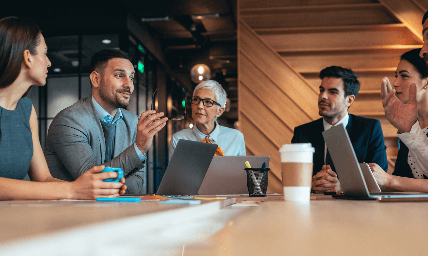 Professional sitting at board room table in meeting