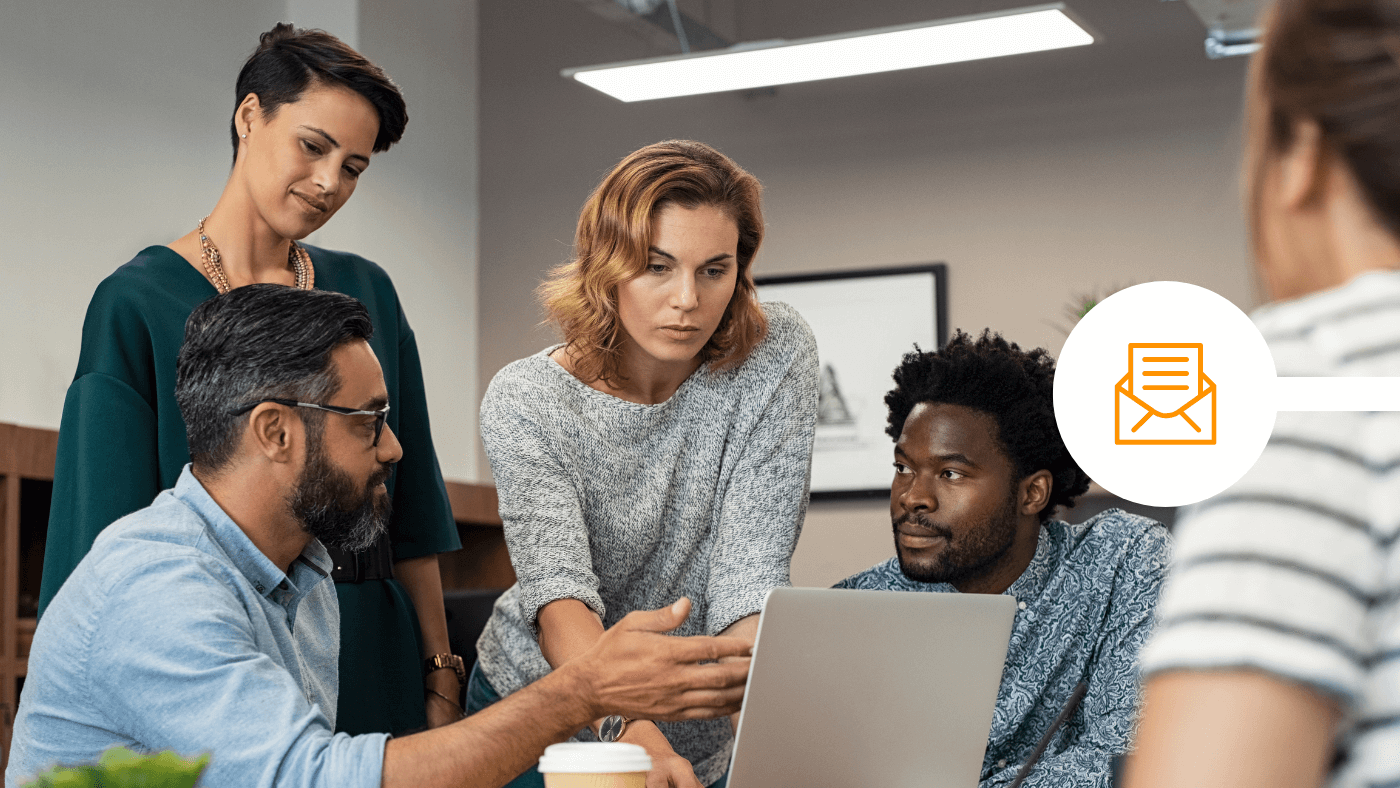 Team discussing how to secure emails in office with laptop