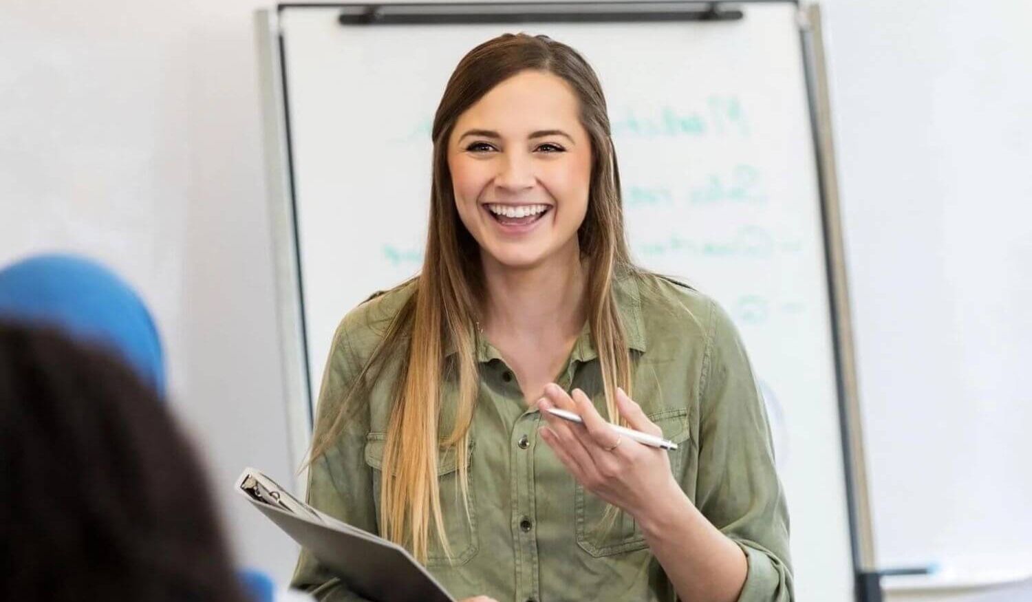 Trainer at office training with clipboard smiling-1