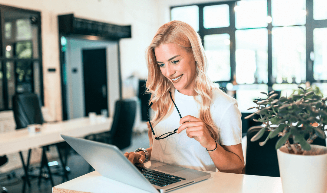 Woman looking at laptop in office (1)