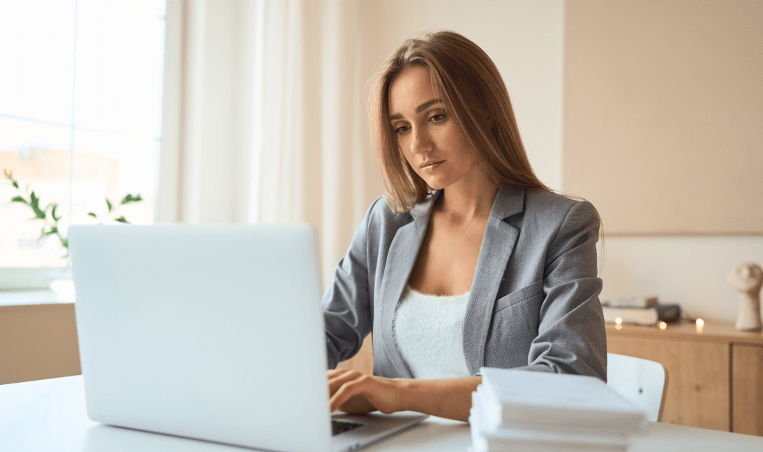 Woman looking at laptop in office