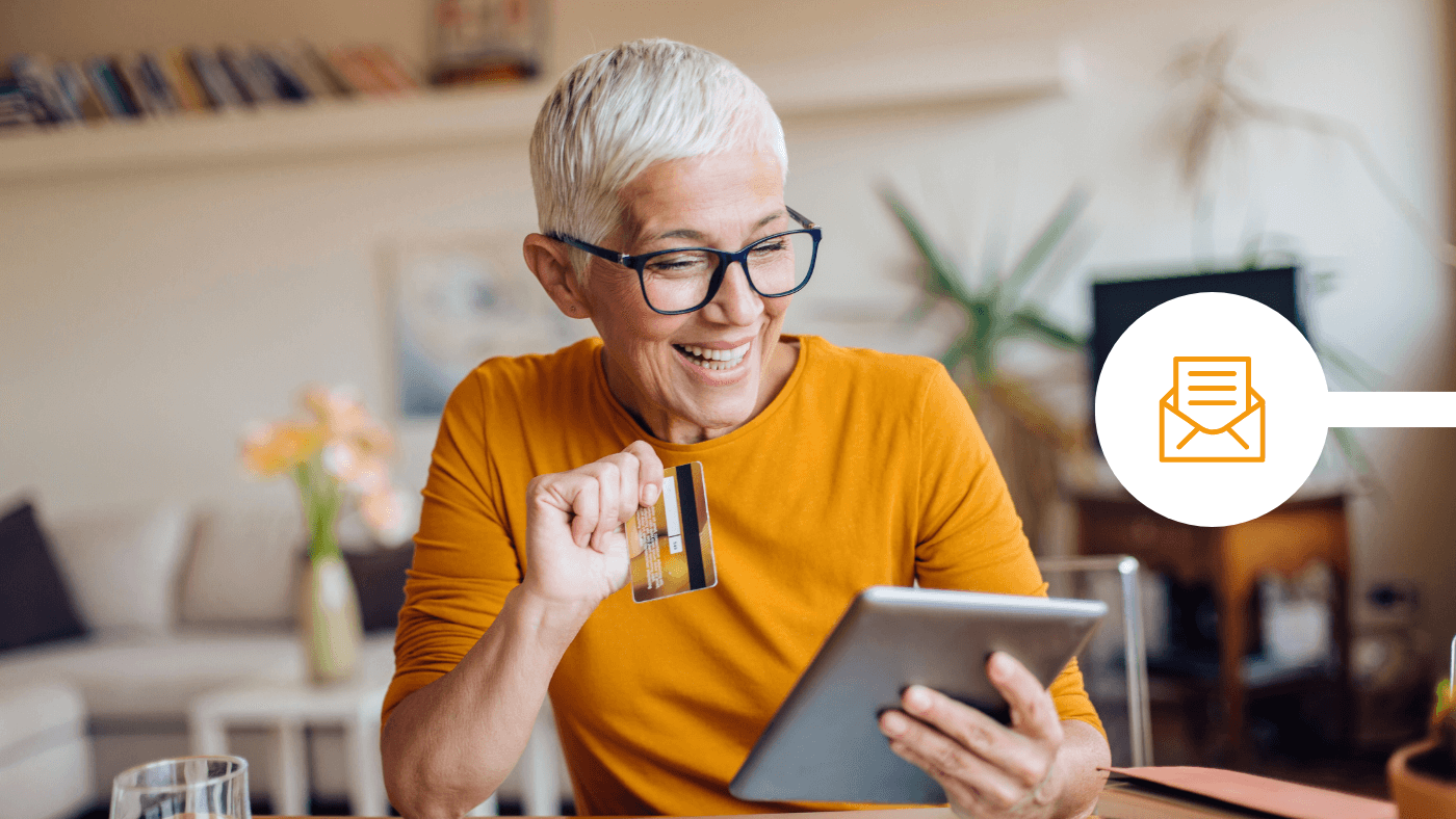 Woman using credit card with tablet