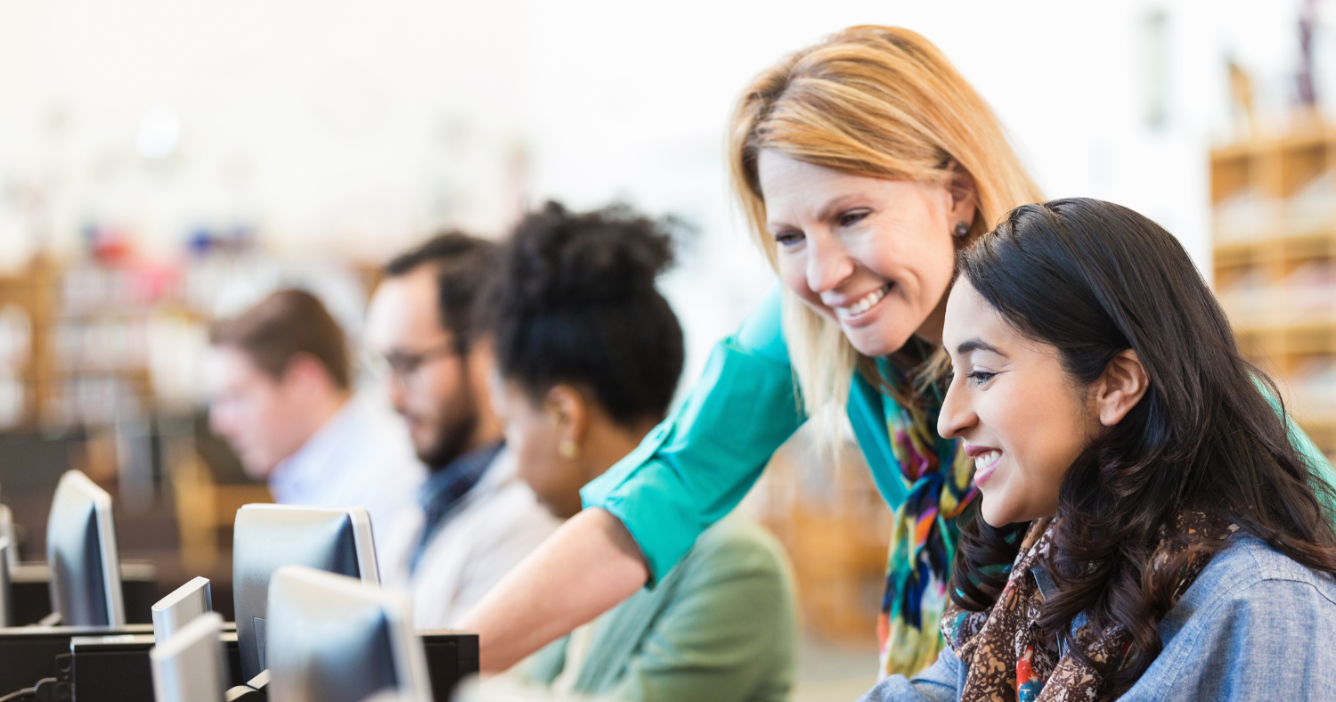 female technology company manager training younger staff