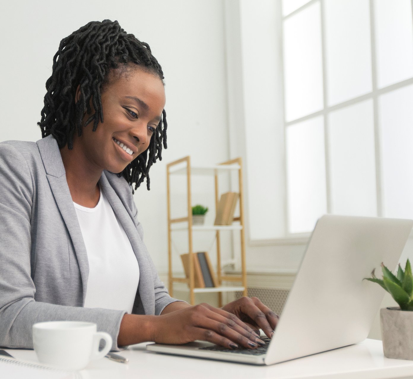 woman working on laptop using secure encrypted email to communicate with clients