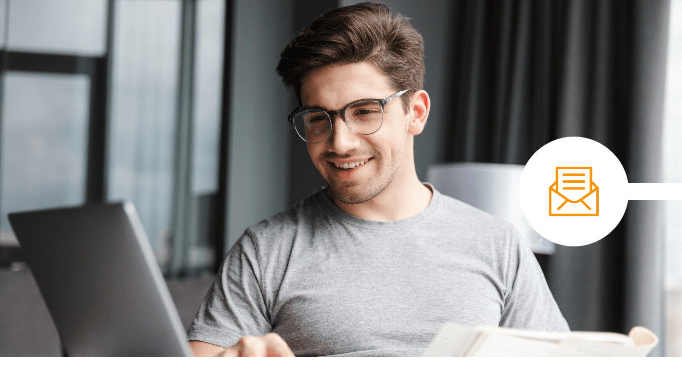 man reading his emails on laptop in his office