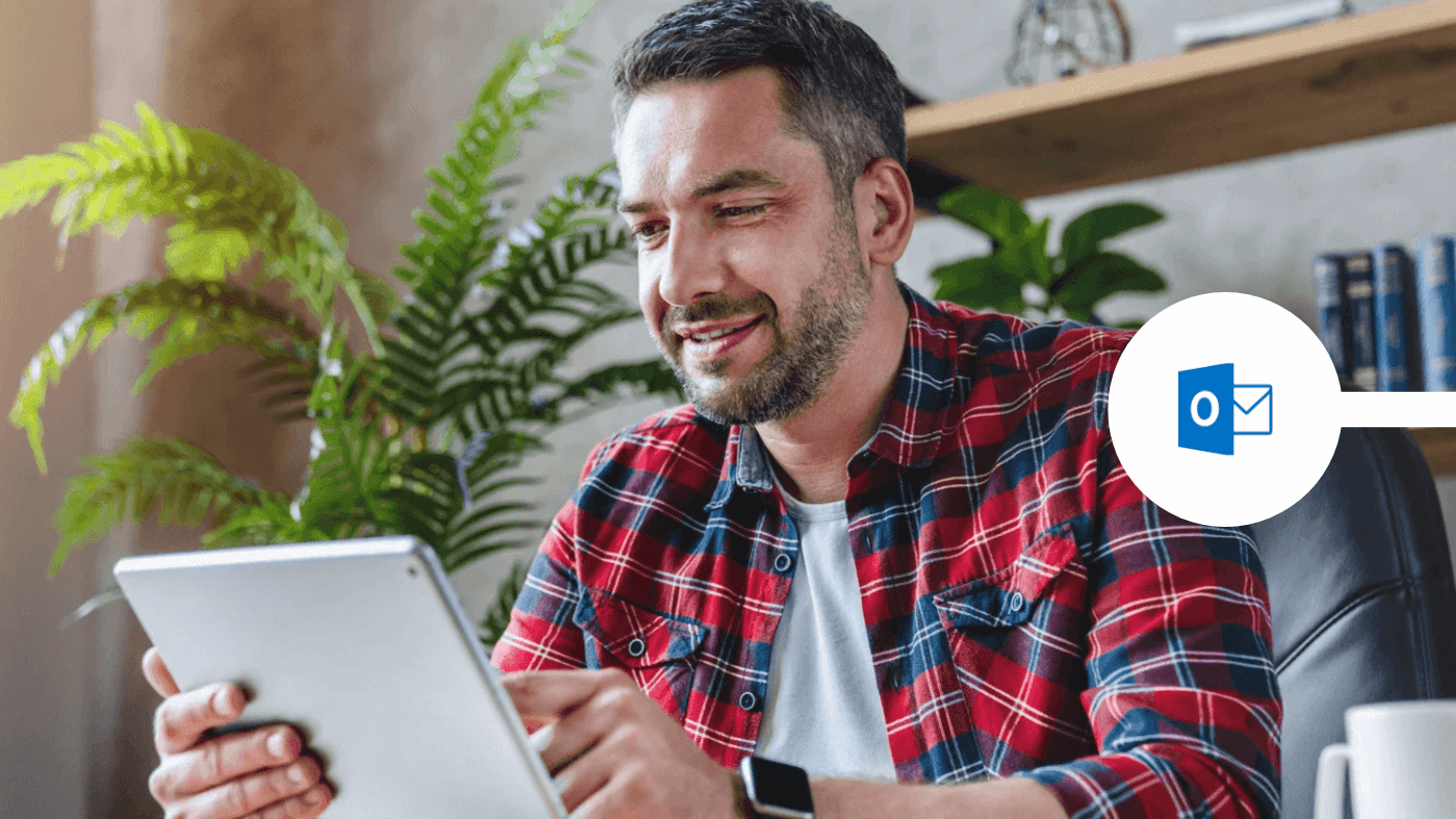 man using outlook on device in his office